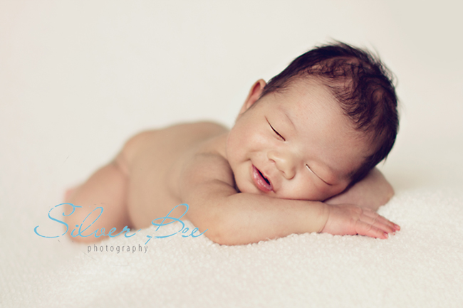 Newborn boy sleeping on bean bag