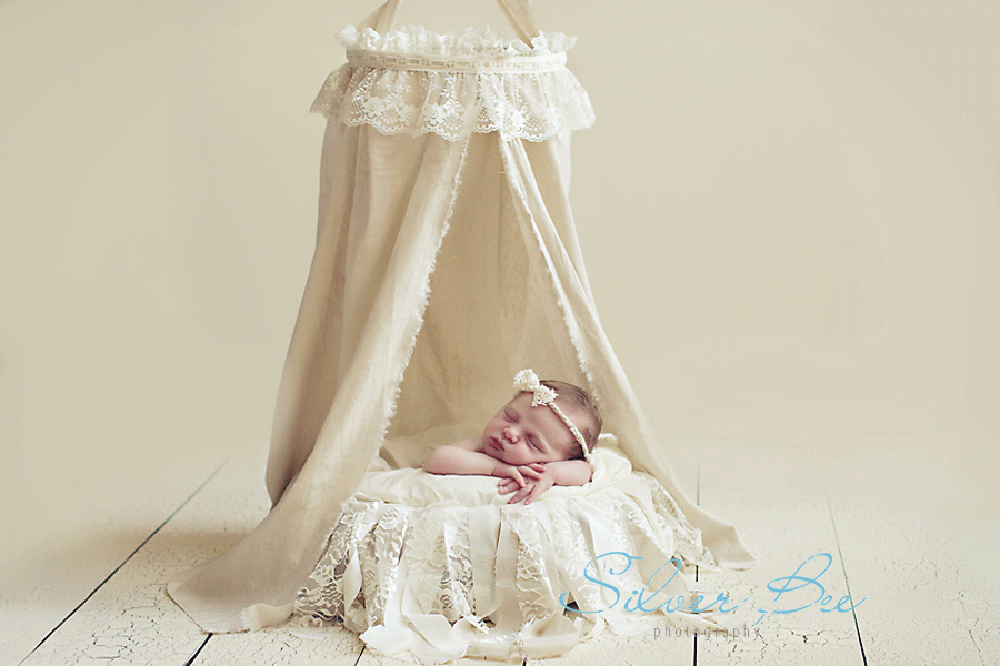 baby girl with linen canopy