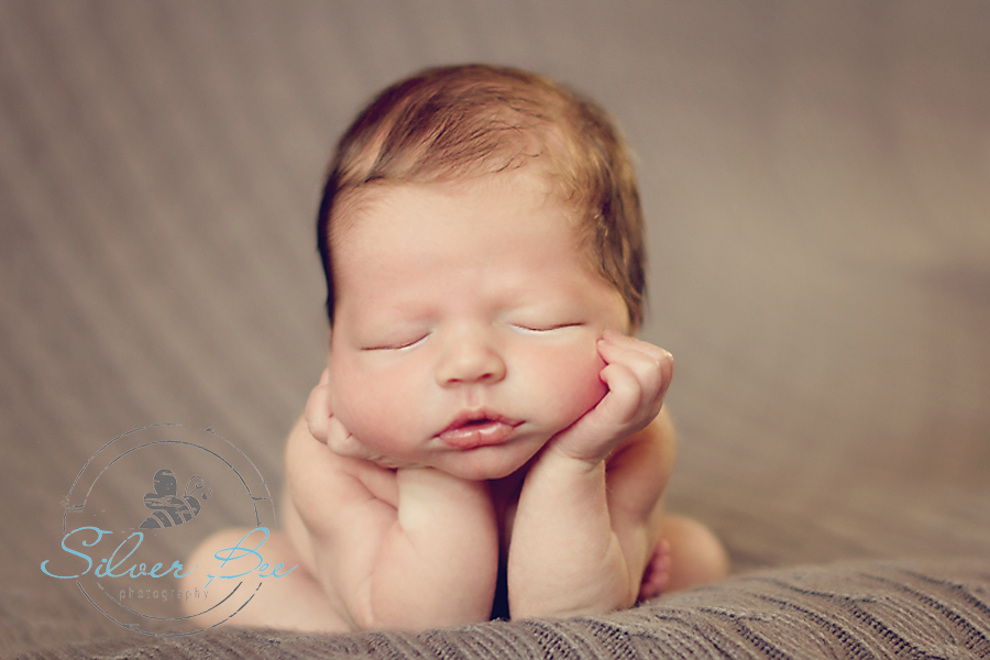 6 day old newborn boy in froggie pose on neutral boucle blanket sleeping, Austin Tx