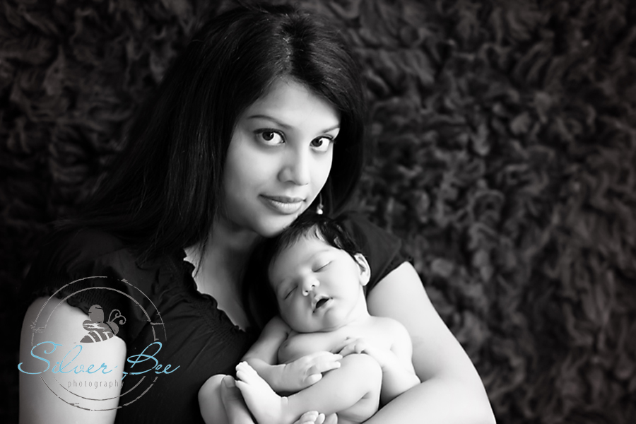 Austin Newborn Photography: Mom holding her 6 day old newborn baby girl at newborn photo session in Austin Texas