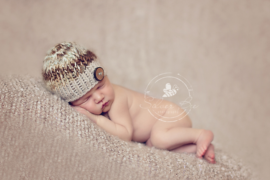 Fall colored newborn baby boy photo session with brown striped knitted hat and brown boucle blanket in Cedar Park Texas.