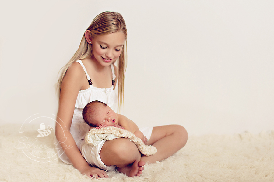 Big sister and newborn baby brother in Austin, Texas sibling photography session.
