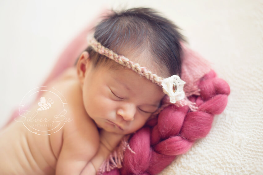Austin Newborn Photographer with baby girl with pink headband