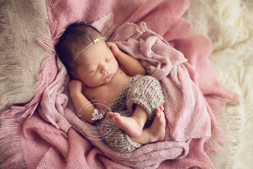Newborn photo session in Austin Texas with pink layering set and newborn pants prop.
