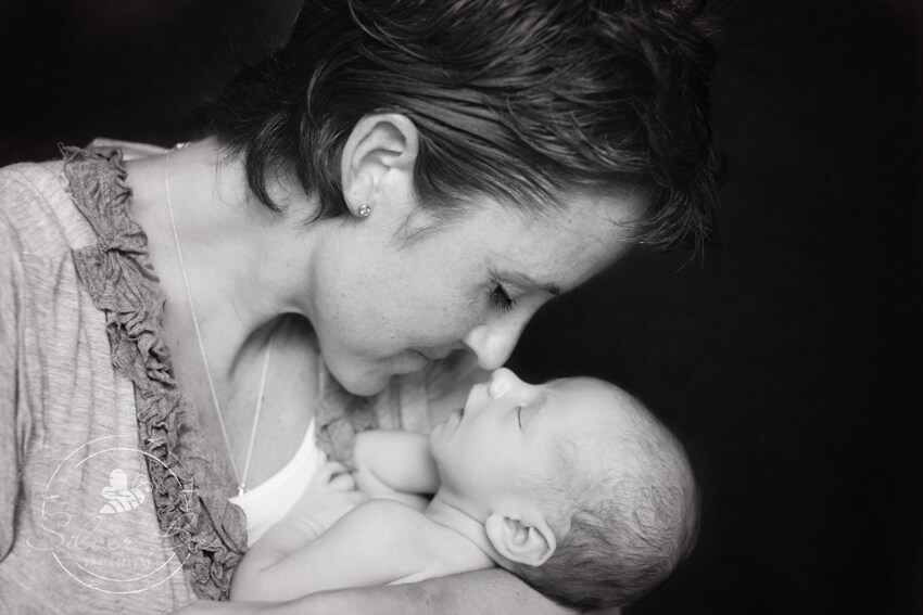 Gorgeous photo of mother and her newborn son posing for portrait session