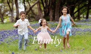 Siblings running through the blue bonnets in Austin Texas